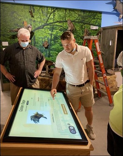 DH WEB staff at Tuscarora Wildlife Education Project looking at Kiosk screen